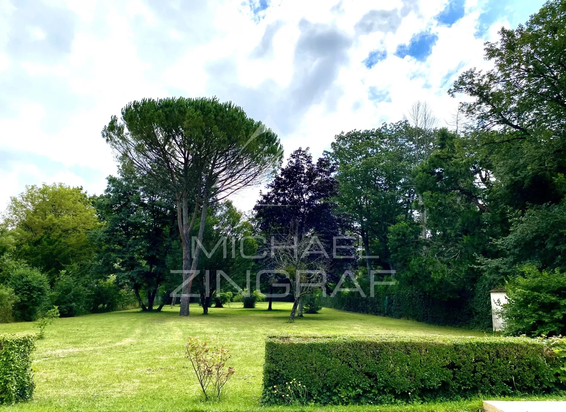 19th century house with swimming pool in wooded park along the river